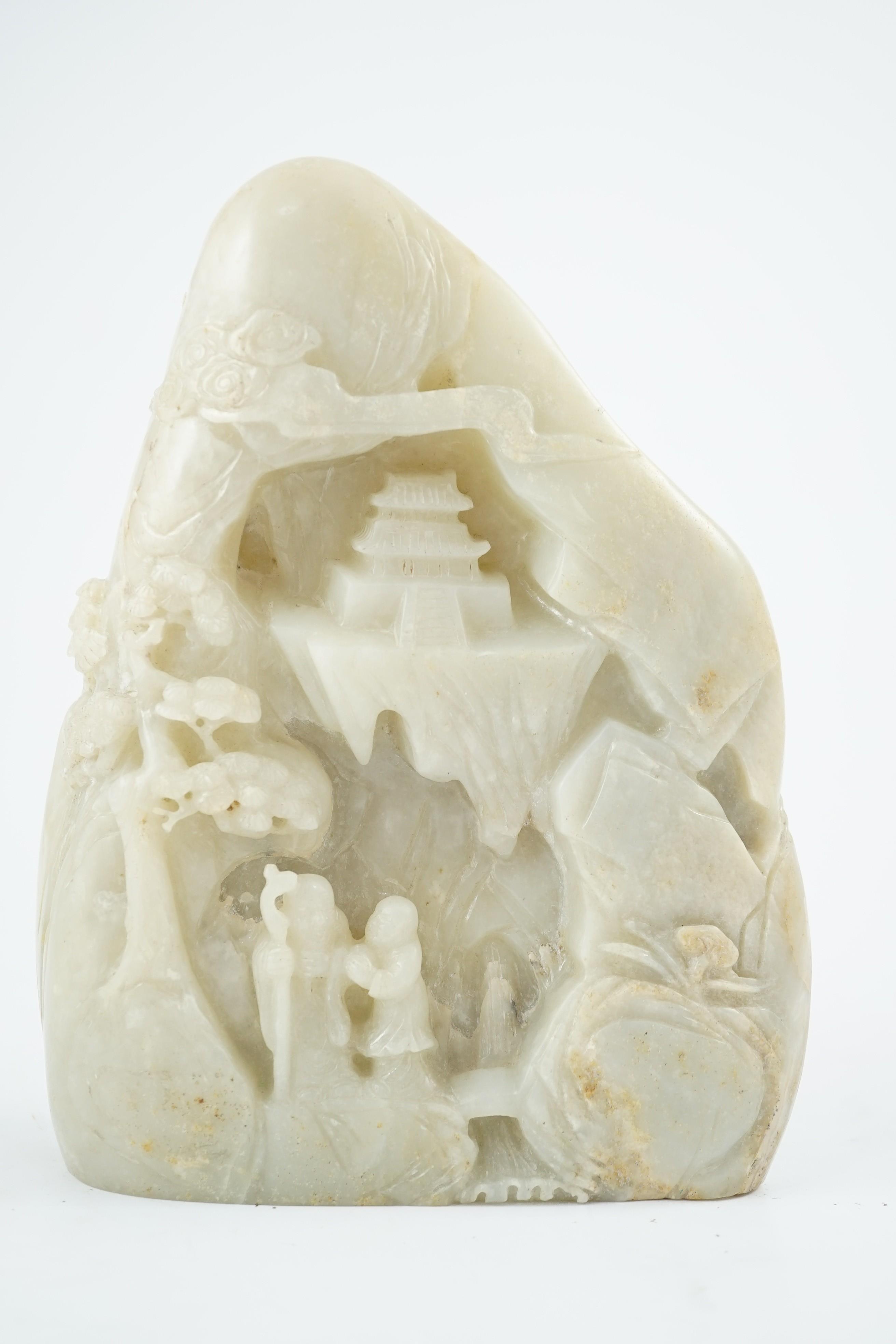 A Chinese pale celadon jade boulder carving, 21cm high 15.5cm wide